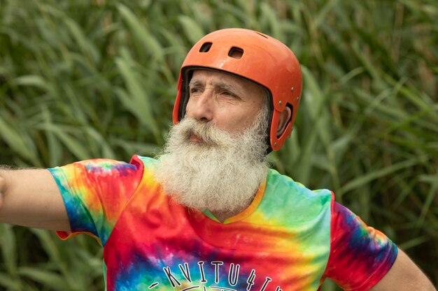 Bearded senior man prepared for water rafting serious look.