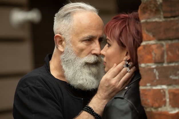 Bearded Senior man and woman wearing leather jackets. Happy couple of retirees in biker clothes.