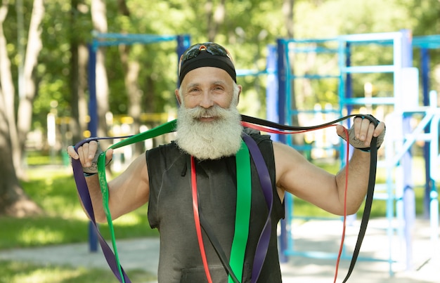 Bearded senior man working out in nature