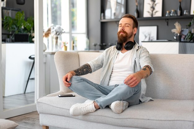 Bearded smiling handsome young man portrait alone at home