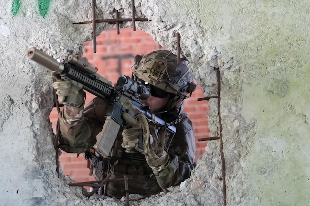 A bearded soldier in uniform of special forces in a dangerous military action in a dangerous enemy area Selective focus