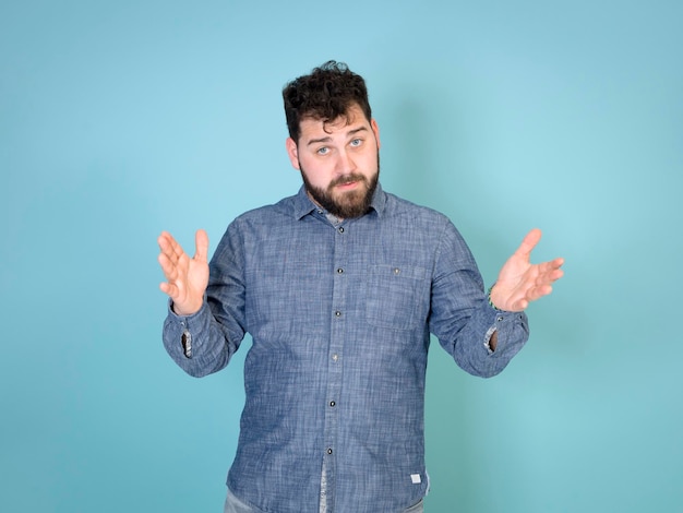 Bearded young man against blue background