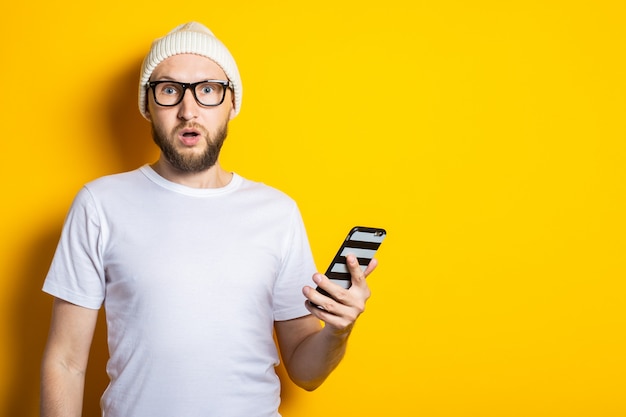 Bearded young man in a hat and glasses