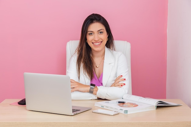 Beautician doctor successful entrepreneur woman professional portrait beautician aesthetic businesswoman At a table with a notebook sitting with arms crossed