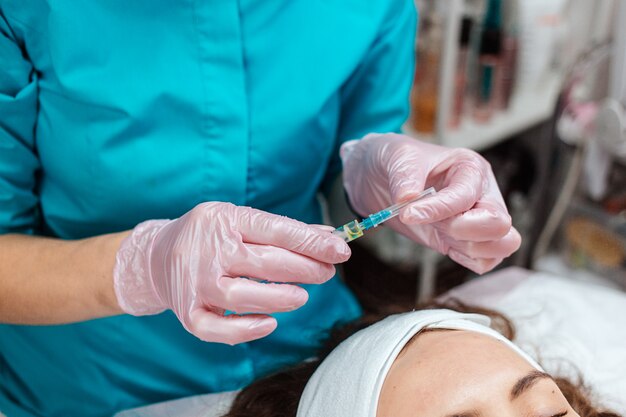 Beautician holding a syringe