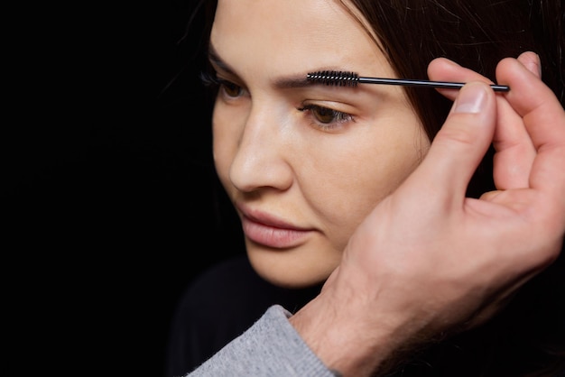 Beautician makeup artist applies paint henna on previously plucked