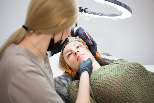 Beautician prepare client for lips permanent make up procedure