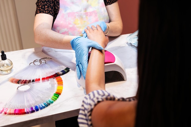 Beautician preparing the client to paint her nails