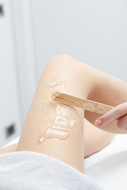 Beautician Removing Hair Of Young Woman with laser