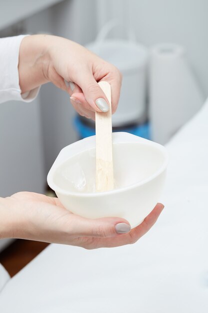 Beautician Removing Hair Of Young Woman with laser