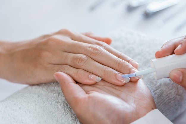 Beautician using a nail polish