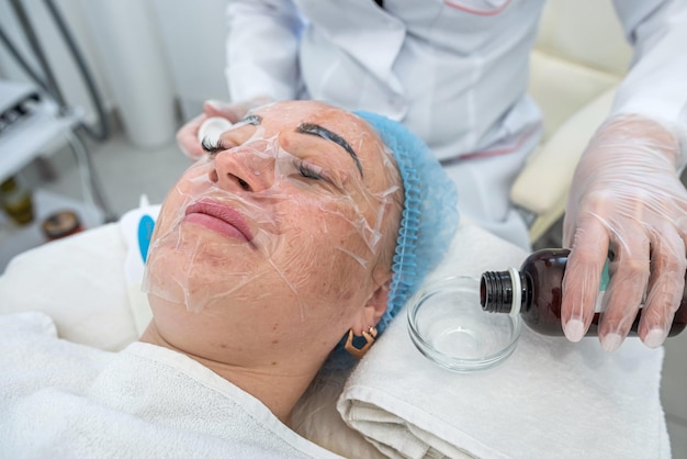 Beautician will do a procedure for a girl in a cosmetology clinic