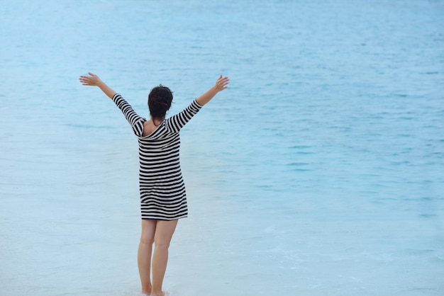 Beautifel and happy woman girl on beach have fun and relax on summer vacation over the beautiful tropical sea