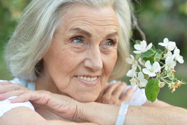 Beautifil elderly woman posing in autumn park