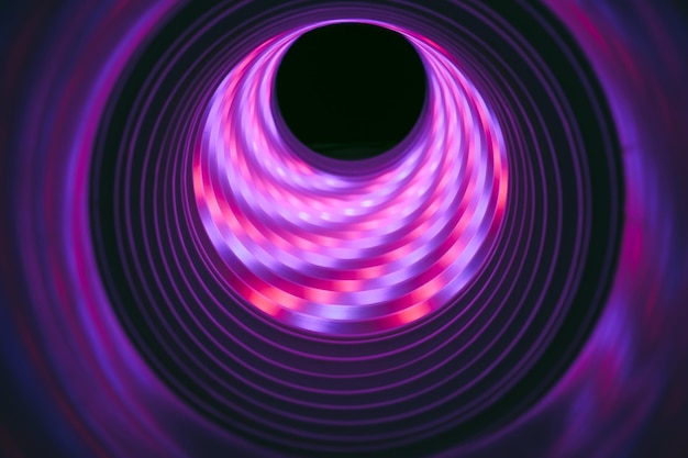 Photo beautiful abstract swirl tunnel with purple neon light on a background pttern textured for deisgn