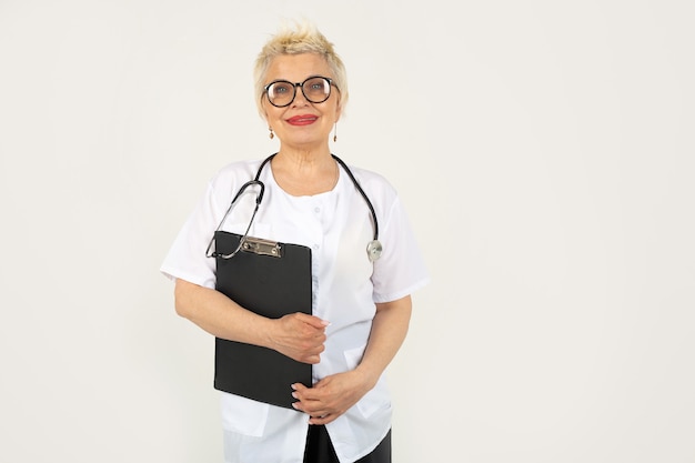 beautiful adult woman aged in glasses and a medical gown