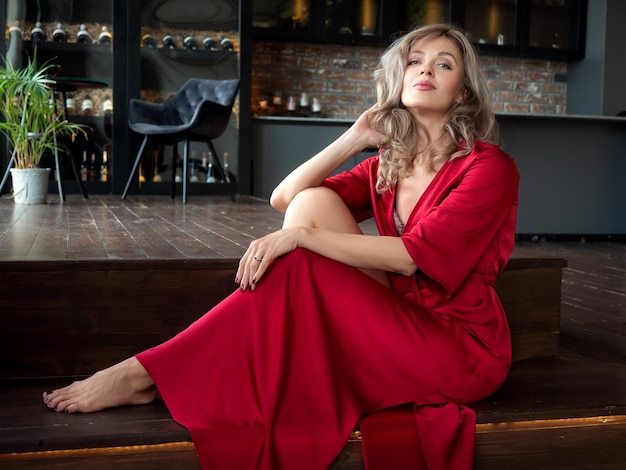 Beautiful adult woman sitting in the kitchen