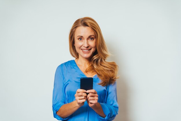 Beautiful adult woman using a smartphone