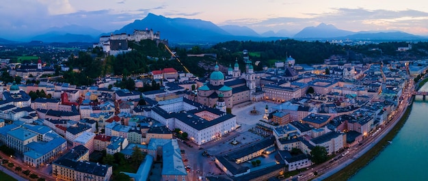 Beautiful aerial drone panorama of Salzburg city in Austria during night View of the historic city of Salzburg and Salzach river at summer