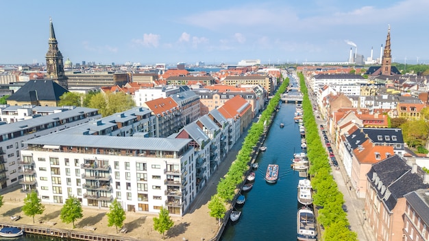 Beautiful aerial view of Copenhagen skyline from above, Nyhavn historical pier port and canal with color buildings and boats in the old town of Copenhagen, Denmark