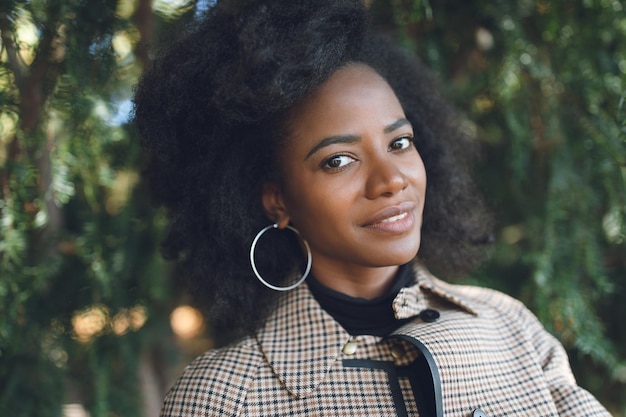 Beautiful african american woman in spring or fall park