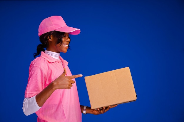 Beautiful african delivery woman holding a package