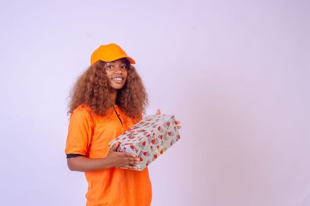 Beautiful african female courier worker holding a box