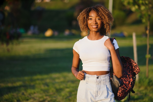 Beautiful african girl walks in the park.