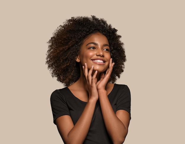 Beautiful african woman black t-shirt portrait afro haircut touching her face Color background brown