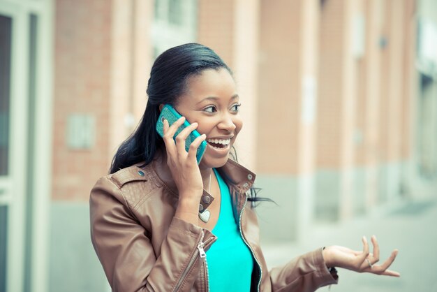 beautiful african young woman using smartphone