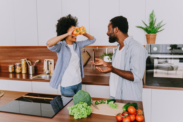 beautiful afro american couple cooking at home