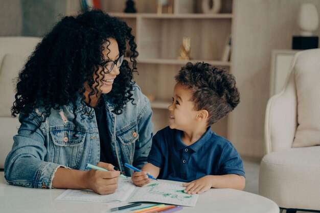 Beautiful afro american family of mother and son spending time at home