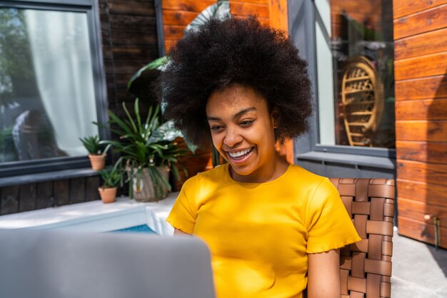 Beautiful afro-american woman with curly hair at home