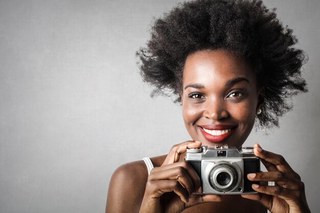 Beautiful Afro woman with a camera