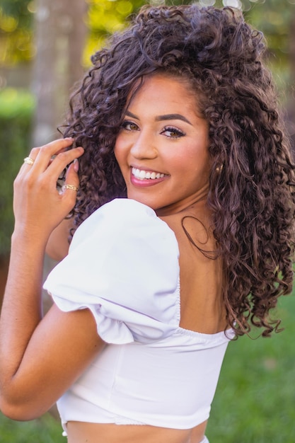 Beautiful afro woman with curly hair smiling