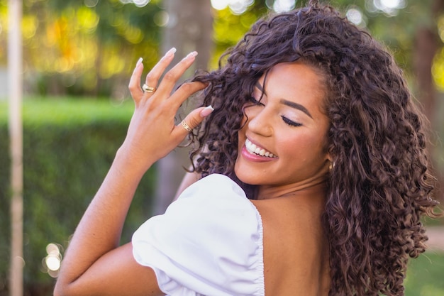 Beautiful afro woman with curly hair smiling