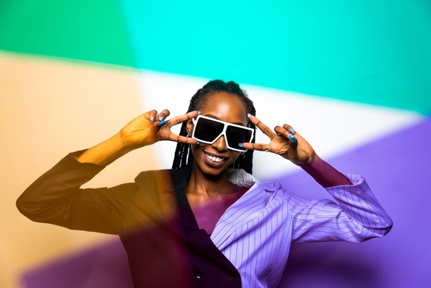 Beautiful afroamerican woman with afro pigtails hairstyle and stylish clothes