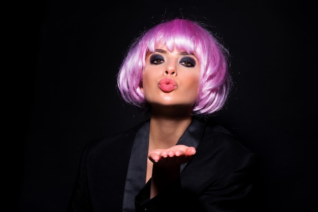 Beautiful air kiss of beauty model fashionable pink wigs photo of young beautiful woman with pink wi