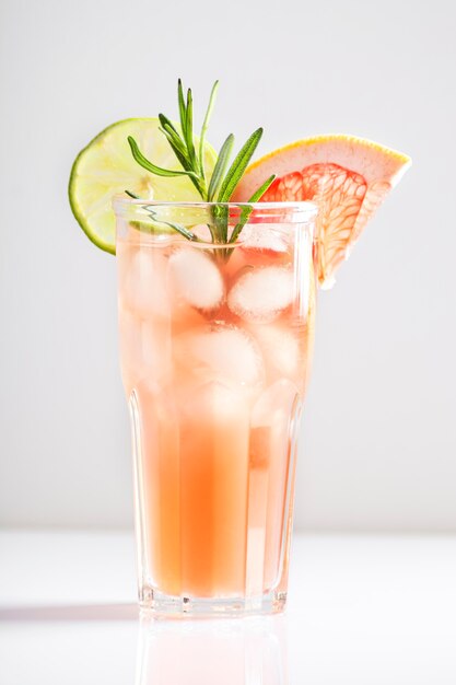 A beautiful alcoholic cocktail of paloma with ice tequila lime and grapefruit