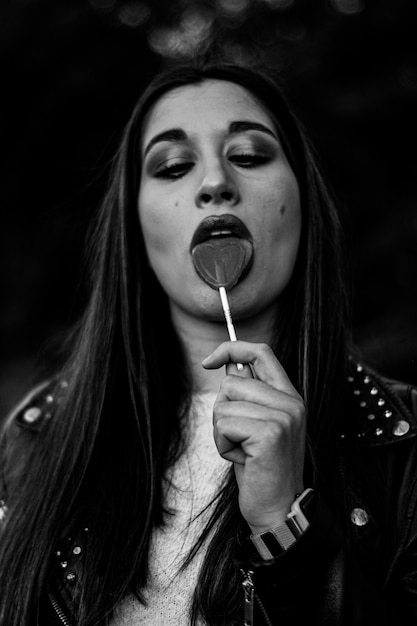 Beautiful amazing sexy smiling woman with an amazing lollipop outdoors