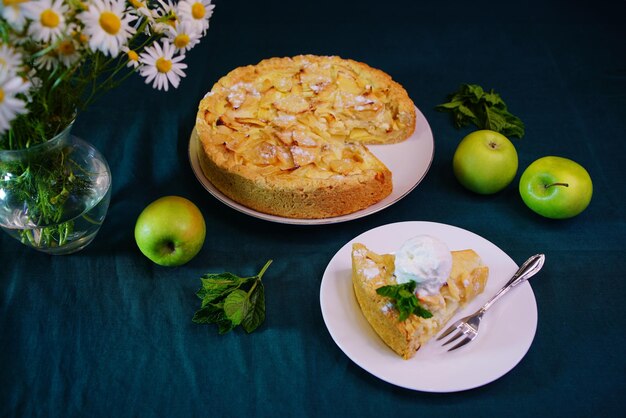 Beautiful apple pie on the table with flowers