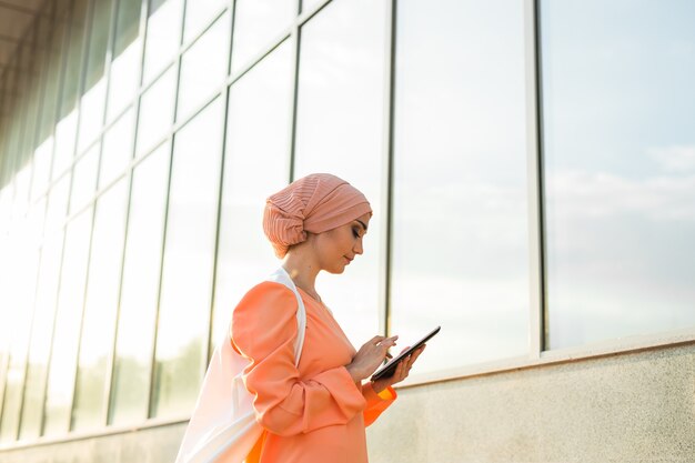 Beautiful arabian girl with tablet computer outdoor