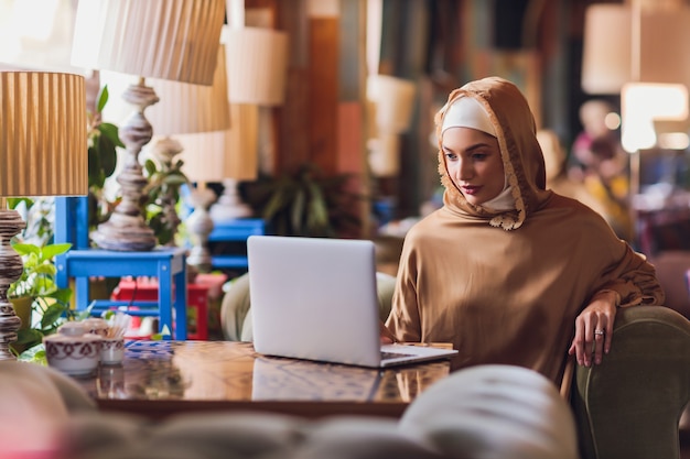 Beautiful Arabic business woman working on computer.