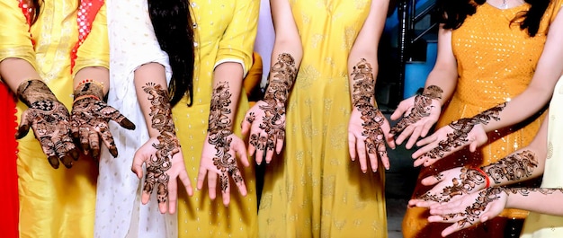 Beautiful artwork drawn on the hand of an Indian bride with herbal heena in wet condition