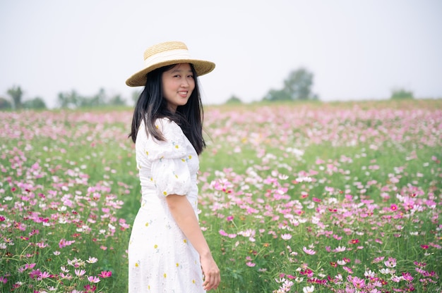 Beautiful Asia woman with white dress in flower garden