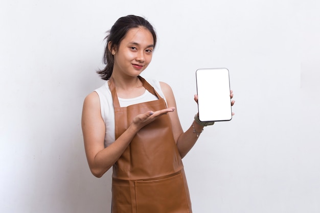 Beautiful Asian Barista waitress demonstrating mobile cell phone on white background