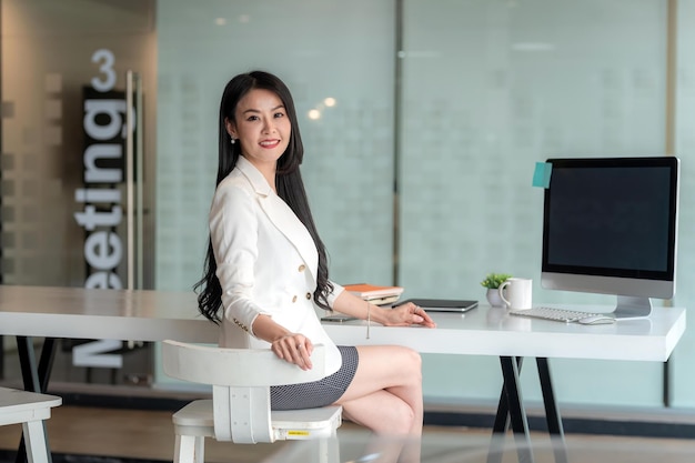 Beautiful Asian businesswoman sitting chair in a work Looking at the camera