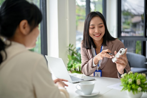 Beautiful Asian female banker talking and planning an investment plan with a client