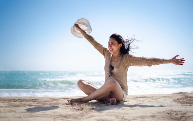 Beautiful Asian female relax on the beach