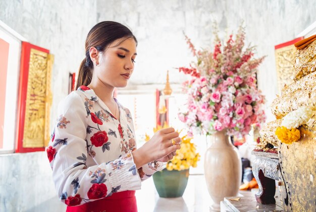 Beautiful asian girl at big buddhist temple dressed in traditional costume